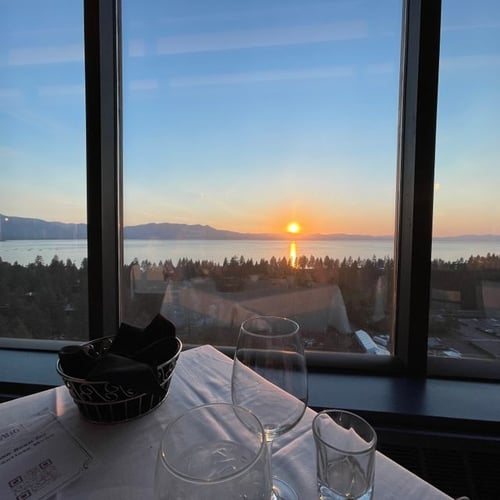 Sage Room Steak House at Caesars Republic Lake Tahoe interior overlooking Lake Tahoe. The Sage Room at Harveys Lake Tahoe offers elevated entrees highlighted by deliciously prepared Black Angus steaks, poultry, veal, lamb, beef wellington, and fresh seafood. For dessert, try the decadent bananas foster and cherries jubilee, both prepared tableside. Located on the 19th floor of Caesars Republic Lake Tahoe, Sage Room overlooks the lake and mountains, offering unmatched scenic views. The Western-themed décor includes original Native American lamps gifted from the Washoe Tribe. Experience the sophisticated yet rustic atmosphere of a landmark restaurant.