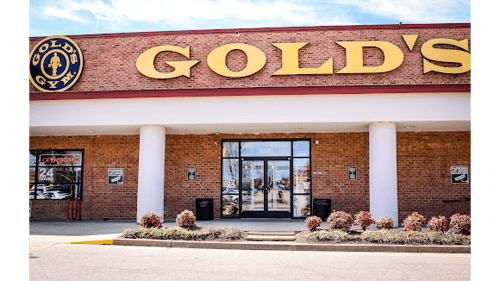 Exterior view of Gold’s Gym East End with large yellow signage and glass entrance.