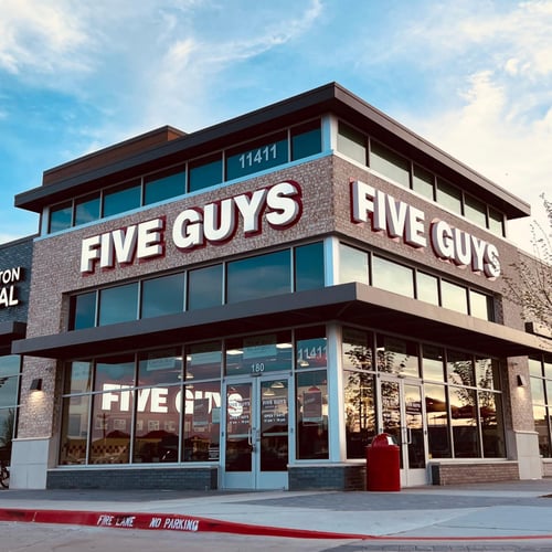 Exterior photograph of the Five Guys restaurant at 11411 Coit Road in Frisco Texas.