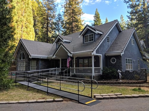 Black modular ramp with a turn platform in front of a home in Pioneer, CA.