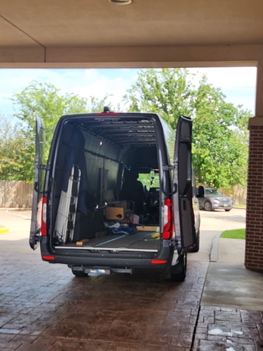 black van parked in garage with its back opened