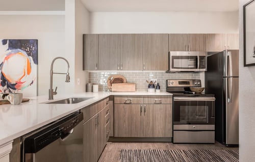 Kitchen at Legacy at Highlands Ranch Apartments with stainless steel appliances and modern finishes.