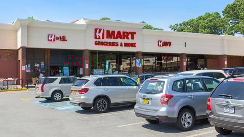 Cars lining the parking lot of H Mart