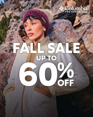 Person wearing Outerwear leaning on a rock.
