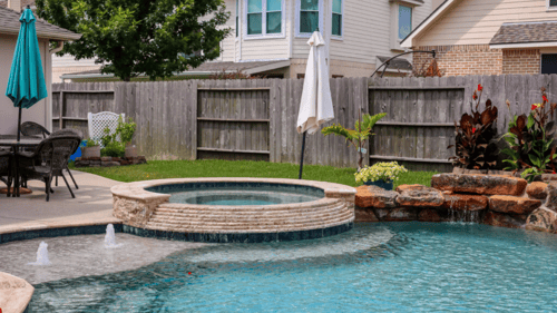 fenced in backyard with custom pool and spa
