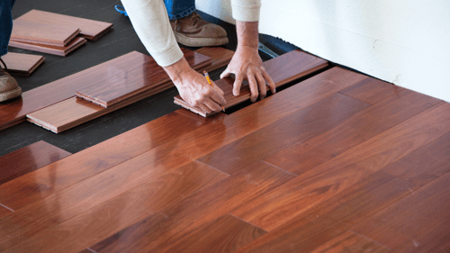 person installing hardwood floors