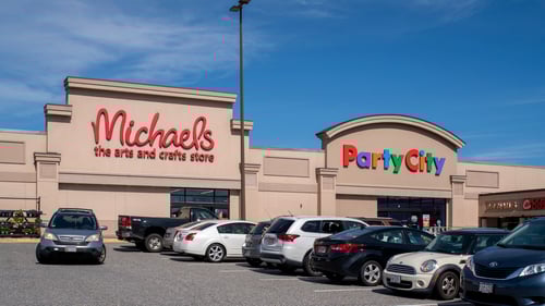 full parking lot in front of Michaels and Party City at Water Tower Plaza shopping center