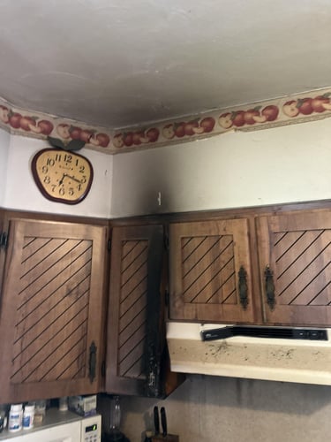 Smoke damage affects the cabinets, wall, and ceiling above a fire in a residential property in Mt. Pocono