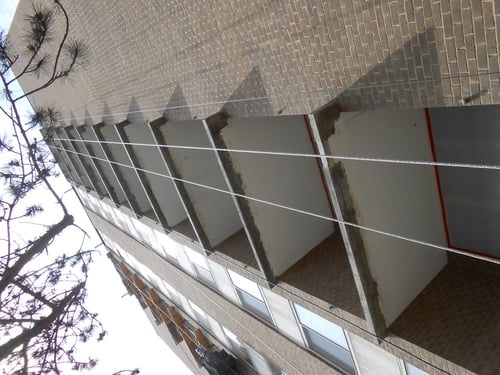 Brown and tan building in the middle of construction