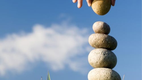 Person Stacking Rocks