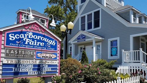 Signage and storefront at Scarborough Faire Shopping Village in Duck, NC.