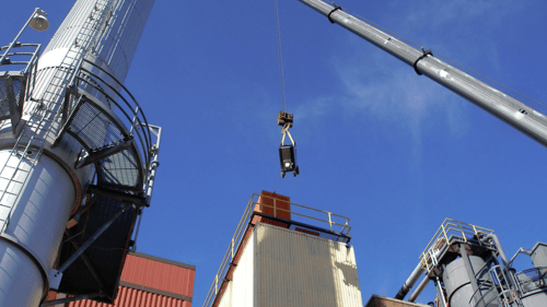 blaster being hoisted over building