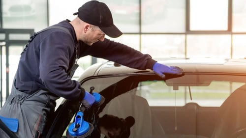 technician repairing a car windshield