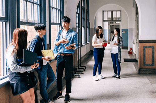 students talking in a school hallway