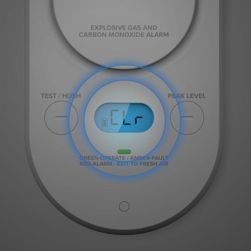 A CO alarm with the display lit and circles highlighting the screen.