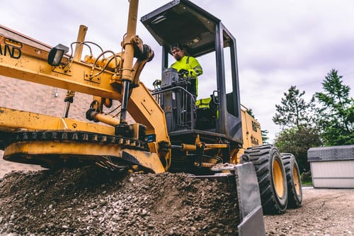 PLM Paving and Concrete employee operating an excavator