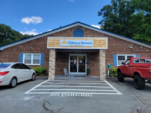 Front view of the school building with a welcoming entrance, designed to create a safe and friendly environment for children and families.
