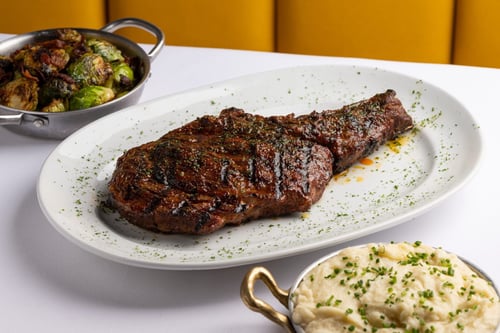Steak dish, mashed potatoes, and brussels sprouts