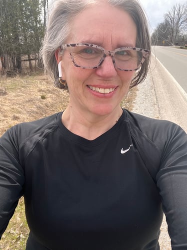 Selfie of Colleen on a running path on a sunny day