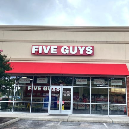 Exterior photograph of the entrance to the Five Guys restaurant at 4105 Chesapeake Square Boulevard in Chesapeake Virginia.
