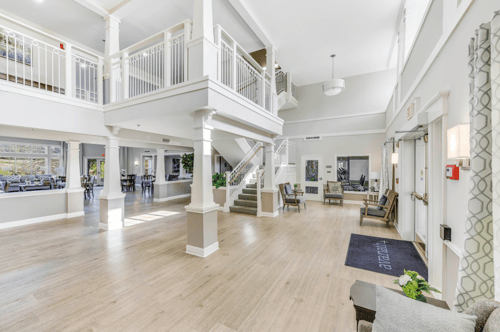 A spacious living room with a staircase and a balcony at Manor at Victoria Park, Temple Hills, MD 20748