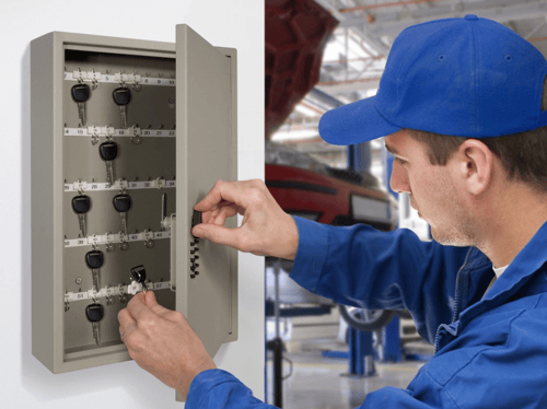 A contractor returns a key to the key cabinet.