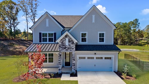 new two-story home with stone accents on tan exterior