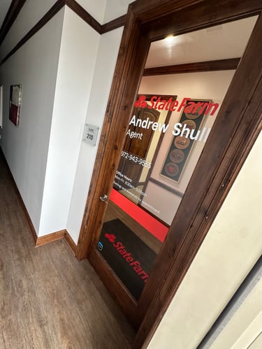 Dark wood door with red State Farm sign