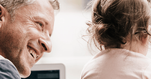 father looking lovingly at his young daughter