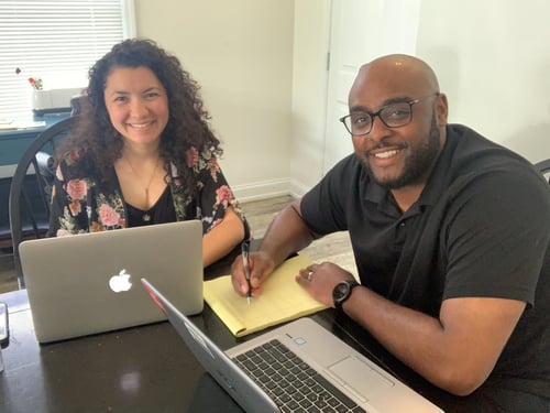 Agent T and team member sitting at desk working together