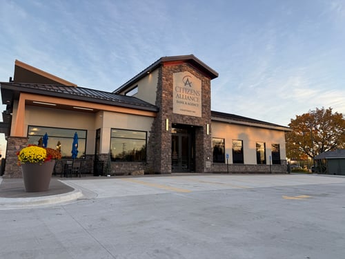 A large, modern-looking building with a stone exterior and a prominent sign reading "Citizens Alliance" above the entrance.