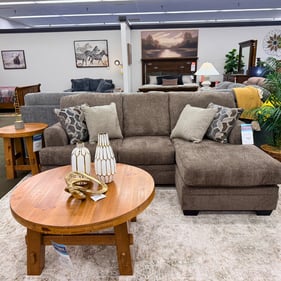 The Stonemeade Sofa Chaise brings comfortable, casual style to any living room with its spacious seating, soft neutral upholstery, coordinating accent pillows, and roomy chaise made for stretching out. Its versatile color and relaxed design make it easy to pair with a variety of décor styles.