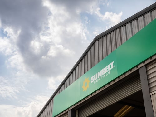 Sunbelt Rentals depot exterior with green branded signage and company logo.