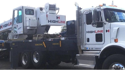 white truck carrying equipment