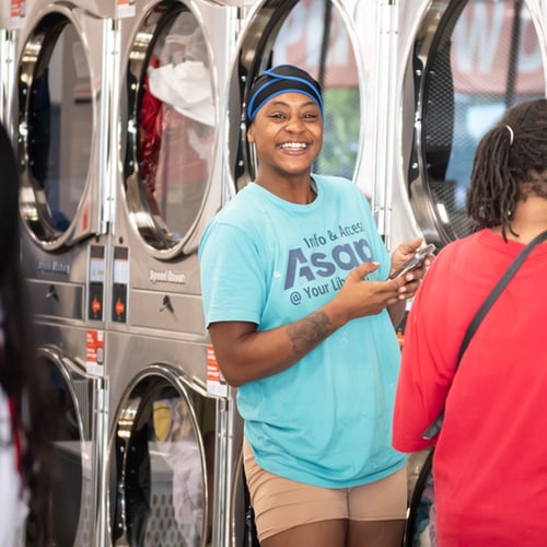 Laundry customer smiling using a Speed Queen washer