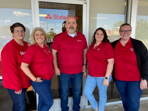 Eric and his team wearing red State Farm shirts