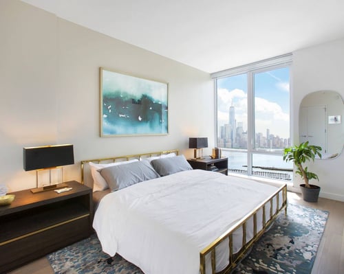 Bedroom with framed art and indoor plant