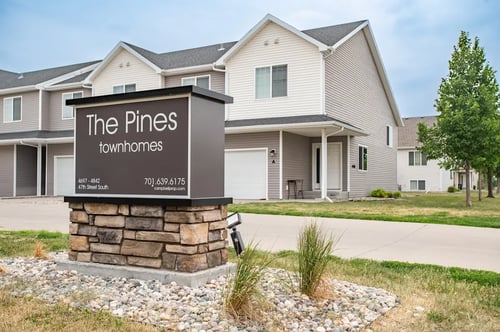 a picture of the pines townhomes sign in front of the house, The Pines Townhomes, Fargo, ND