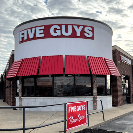 Exterior photograph of the Five Guys restaurant at 1401 S. Walton Boulevard in Bentonville Arkansas.