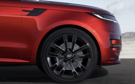 Close up of a red Range Rover front wheel and alloy rim with black detailing