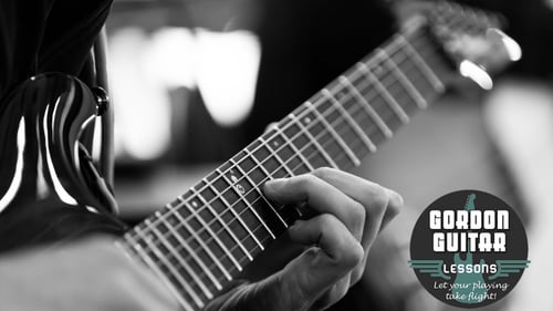 Close up of a person playing electric guitar