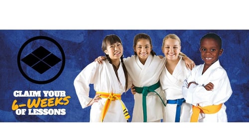 four children in karate class with company logo