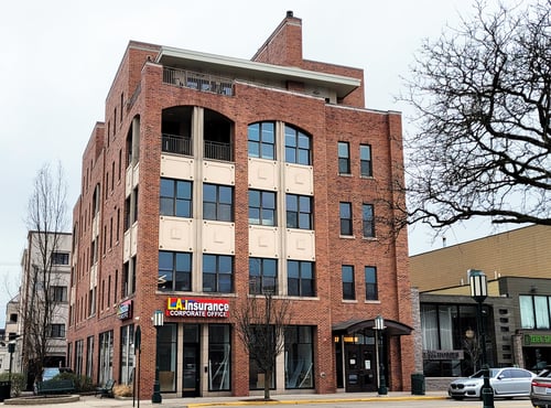 A street corner photo of the L.A. Insurance Corporate Office Building in Birmingham, Michigan.