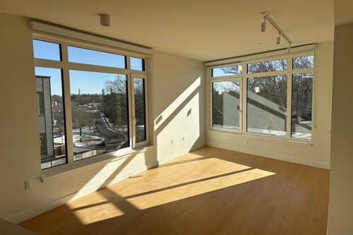 Living room with large windows at 605 Concord at Fresh Pond in Cambridge, MA