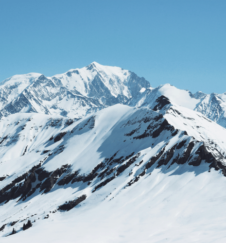 Snow-covered mountains and a clear blue sky