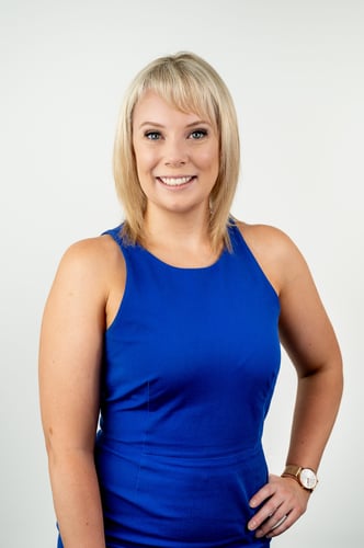 Headshot of Emily Rea in blue dress