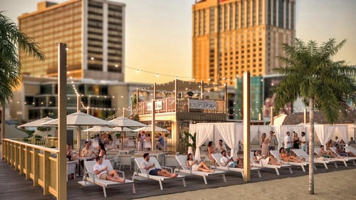 Caesars Beach Club attendees having drinks and lounging.