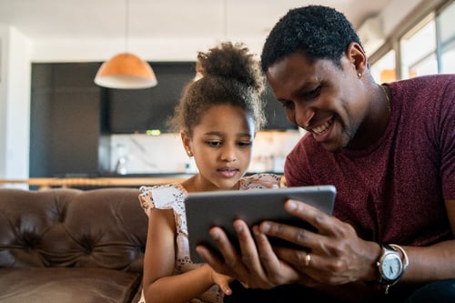 Dad with daughter looking at tablet