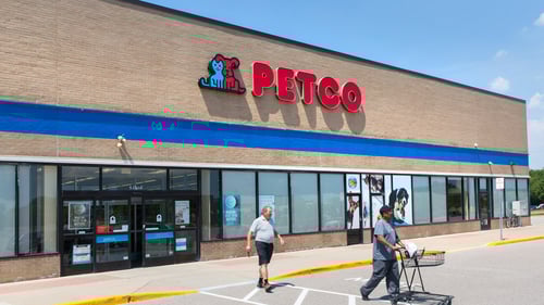 Person with shopping cart walking out of Petco entrance at West Ridge shopping center