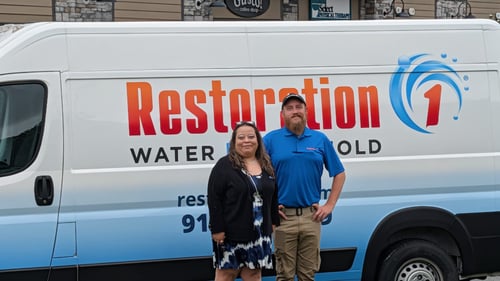 Business Development Representative Yvonne DeJarnatt and Nick Coggin pose in front of the Restoration 1 of Leavenworth Van. We are veteran-owned and operated and available 24/7.
